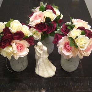 Center Pieces from my wedding. The three bouquets/jars with pink flowers 🌺